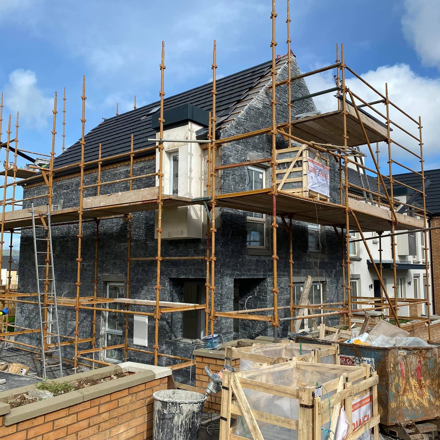 House in the process of stone cladding installation